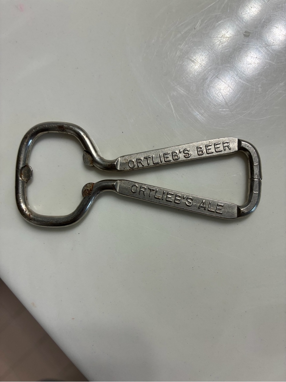 Vintage wire-loop advertising bottle opener from the Henry F. Ortlieb Brewing Co